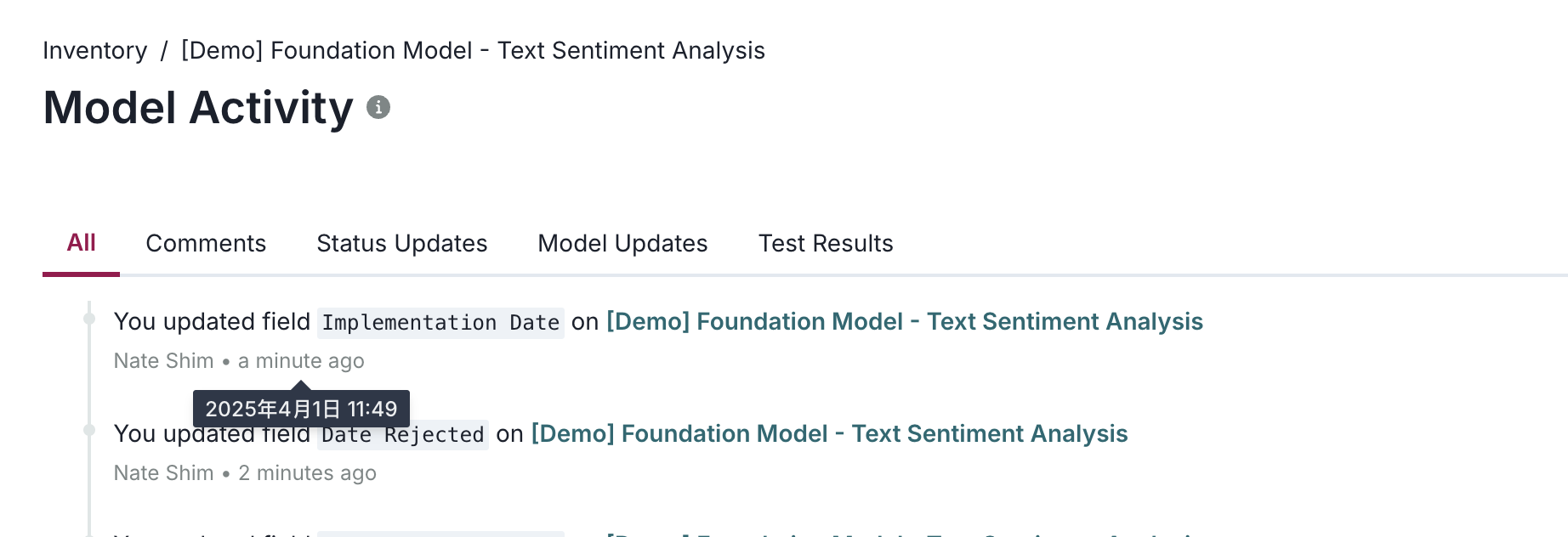 A user interface displaying a section titled Model Activity with tabs labeled All, Comments, Status Updates, Model Updates, and Test Results. The All tab is selected, showing a list of recent activities. The first entry states You updated field Implementation Date on [Demo] Foundation Model - Text Sentiment Analysis with a timestamp tooltip showing 2023年4月1日 11:49. Below, another entry reads You updated field Date Rejected on [Demo] Foundation Model - Text Sentiment Analysis. The layout uses a clean, white background with dark text for clarity and emphasis.